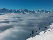 Ski lifts in ski resort with low clouds — Stock Photo