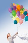 Young woman outdoors with balloons — Stock Photo
