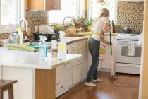 Young woman mopping with green cleaning products — Stock Photo