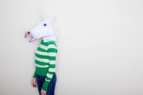 Girl wearing unicorn head mask — Stock Photo