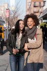 Women walking together on city street — Stock Photo