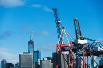 Container cranes and skyscrapers — Stock Photo