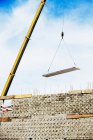 Construction crane carry over building materials — Stock Photo