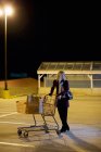 Woman alone in supermarket parking lot — Stock Photo
