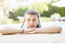 Portrait of teenage girl with wet hair in swimming pool — Stock Photo