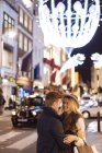Romantic young couple on New Bond street at xmas, London, UK — Stock Photo