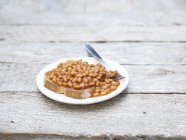 Baked beans on toast with fork — Stock Photo