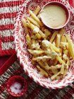 Ciotola di salsa e patatine fritte in piatto — Foto stock