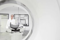 Portrait of female doctor through ct scanner — Stock Photo