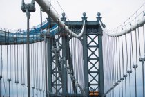 Details of Manhattan Bridge under cloudy sky — Stock Photo
