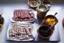 Assortment of cold meat with sauces on table — Stock Photo
