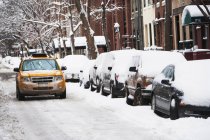 Taxi driving on snowy street — Stock Photo