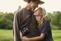 Romantic young couple in rural field — Stock Photo