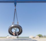 Boy on tyre swing — Stock Photo