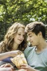 Young couple sharing bag of food — Stock Photo