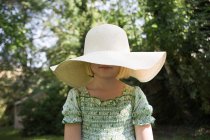 Girl wearing a large sun hat — Stock Photo