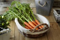 Fresh carrots in basket — Stock Photo