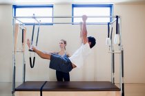 Man doing pilates with instructor — Stock Photo