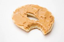 Peanut butter bagel with missing bite — Stock Photo