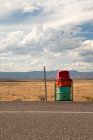 Trash can at side of highway — Stock Photo