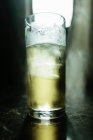Close up of glass of cocktail with ice cube — Stock Photo