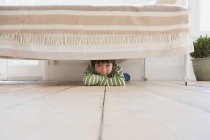 Хлопчик ховається під ліжком — стокове фото