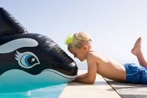Niño con ballena inflable - foto de stock