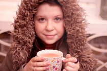 Teenage girl with mug of coffee outdoors — Stock Photo