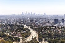 Elevated view of curving highway and city buildings, Los Angeles, California, USA — Stock Photo