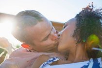 Young couple kissing on balcony, close up — Stock Photo