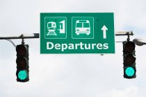 Departure sign with green traffic lights — Stock Photo