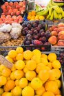 Different fresh fruit in boxes at street market — Stock Photo