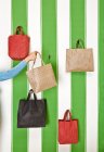 Cropped image of Woman taking bag from display — Stock Photo