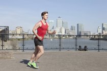 Runner jogging along waterfront, Wapping, London — Stock Photo