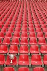 Trophy on empty football stadium seating — Stock Photo