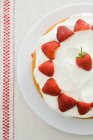 Strawberries on cream cake — Stock Photo
