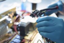 Worker assembling electronics in electronics factory, focus on hands — Stock Photo