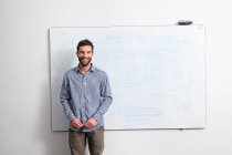 Businessman in front of whiteboard — Stock Photo