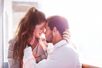 Romantic young couple face to face in office — Stock Photo