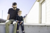 Padre e hijo disfrutando del día al aire libre - foto de stock
