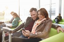 Mature couple in departure lounge — Stock Photo