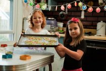 Girls in kitchen baking cookies — Stock Photo