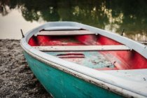 Traditional fishing boat moored by lake, close up — Stock Photo