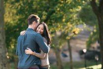 Romantic mid adult couple hugging in park — Stock Photo