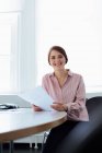 Businesswoman working in office, focus on foreground — Stock Photo