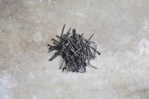Top view of pile of nails on marble surface — Stock Photo