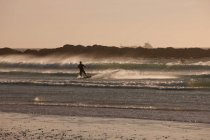Man windsurfing in waves — Stock Photo