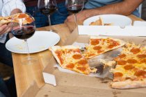 Люди едят пиццу за столом — стоковое фото