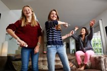 Teenage girls playing video game — Stock Photo