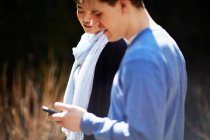 Young couple, man using cell phone — Stock Photo